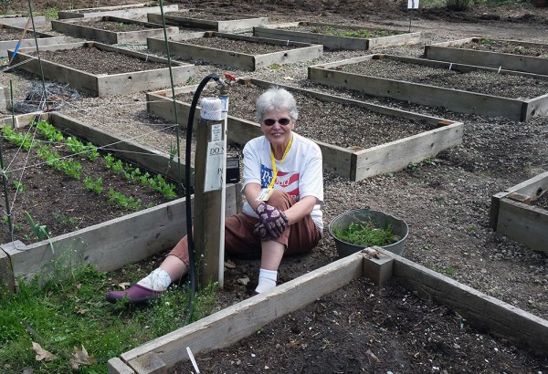 Joanne Jackson smiles as she works on the community garden at Shepherd's Door. 